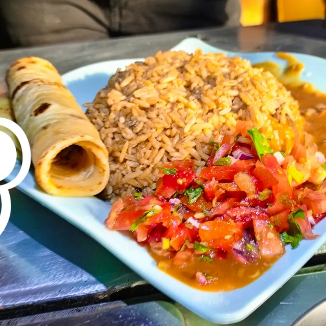 A plate of authentic Kenyan Pilau and chapati at a local budget-friendly restaurant